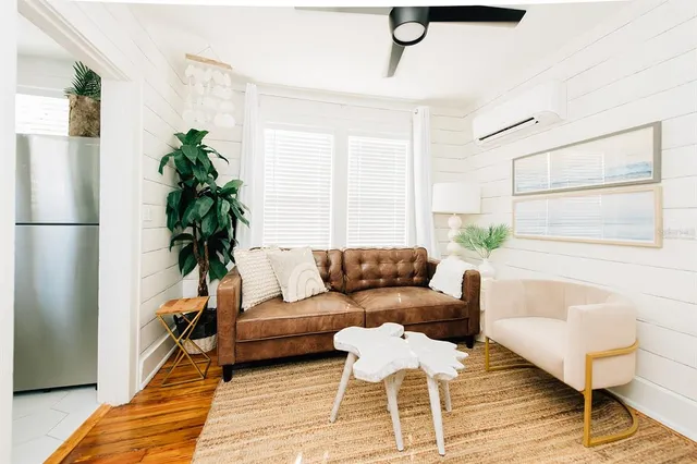 a living room with furniture and a potted plant