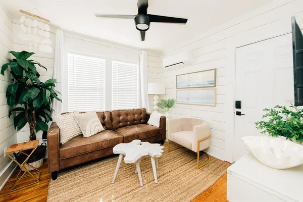 a living room with furniture and a potted plant
