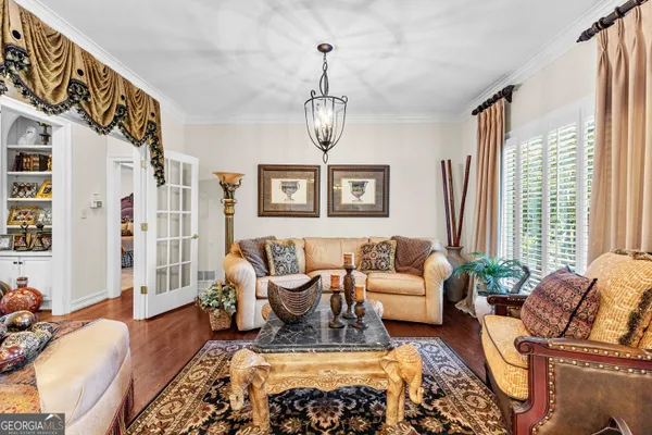 a living room with furniture a flat screen tv and a large window