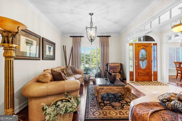 a view of a livingroom with furniture hardwood floor and a ceiling fan