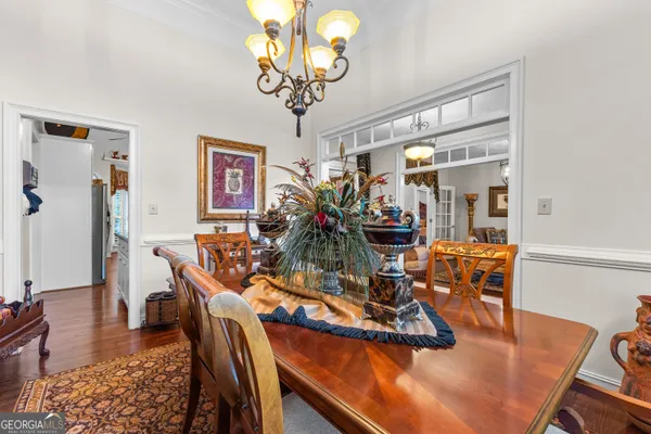 a kitchen with stainless steel appliances granite countertop a stove a sink and a refrigerator with wooden floors
