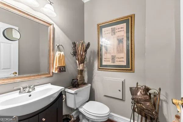 a bathroom with a granite countertop sink a toilet and a bathtub