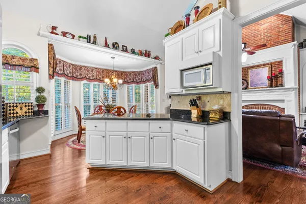 a living room with furniture a table and chairs