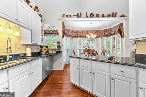 a dining room filled chandelier and furniture