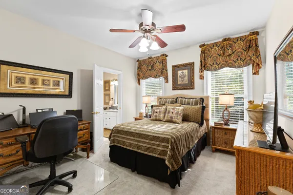 a bedroom with a bed and a television