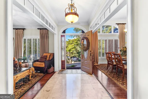 a view of a dining room with furniture and a chandelier