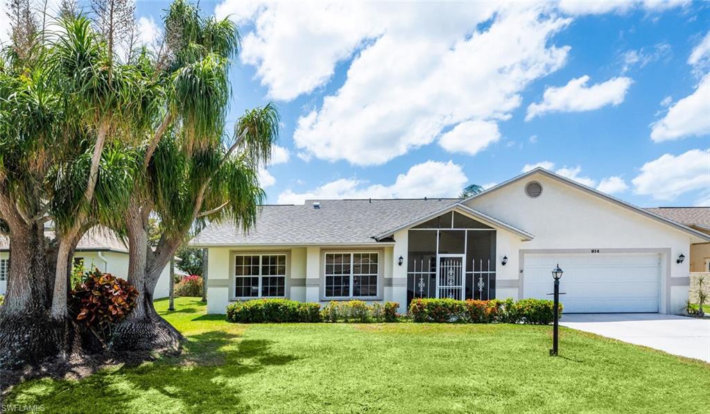 a front view of house with yard and green space