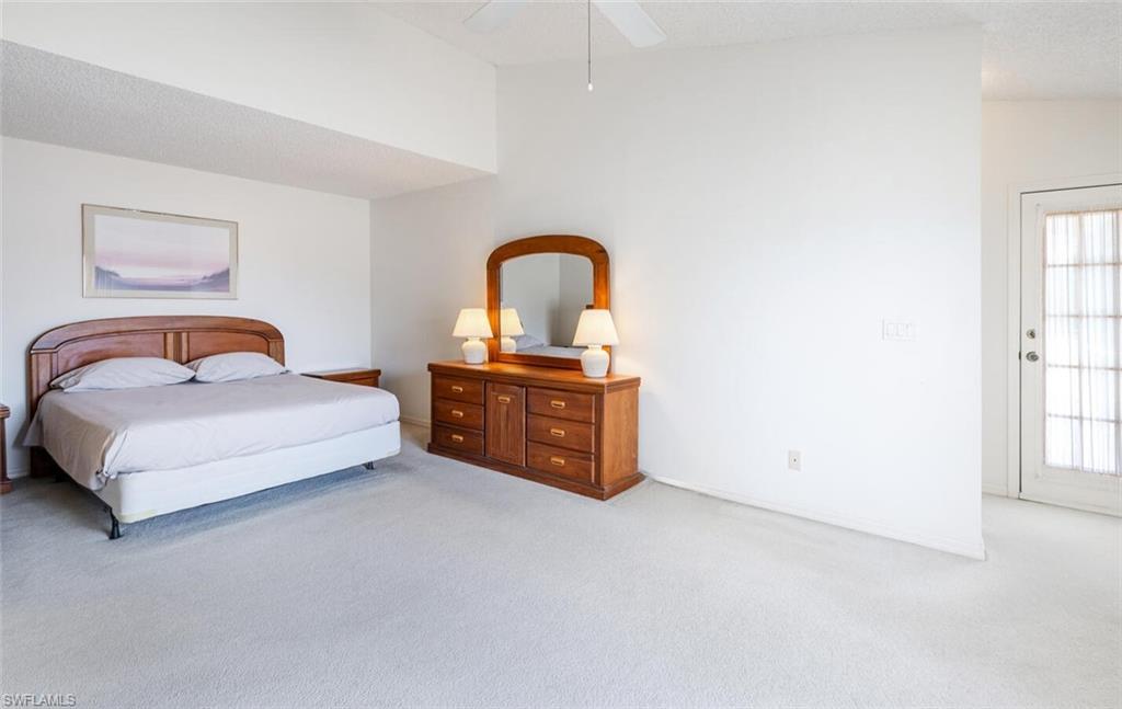 814 Charlemagne Boulevard Naples, FL 34112 - Photo 15 of 33 a spacious bedroom with a bed and a window