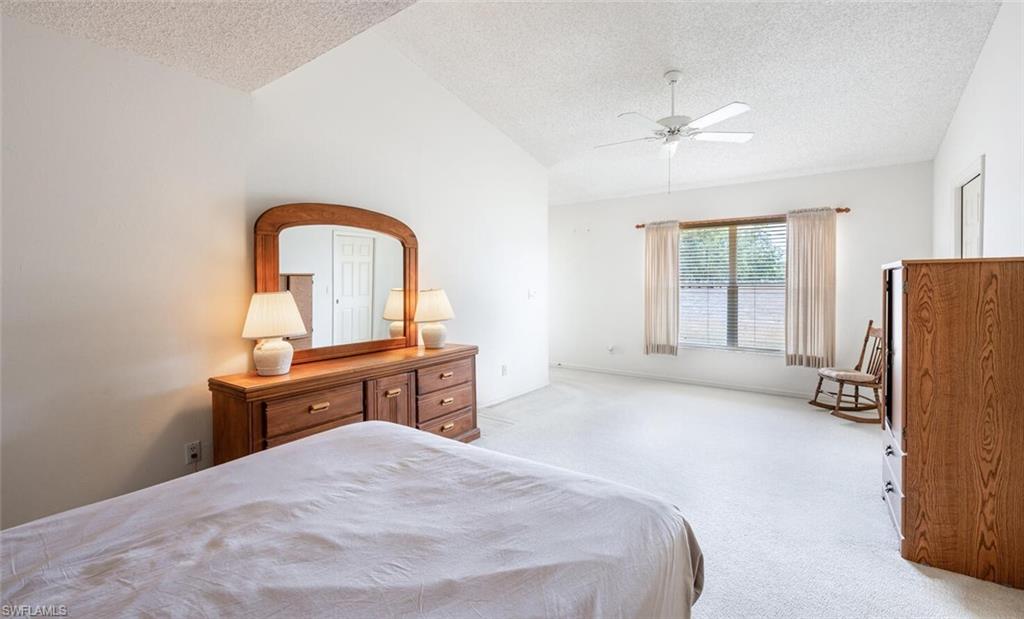 814 Charlemagne Boulevard Naples, FL 34112 - Photo 16 of 33 a bed room with a bed and a television