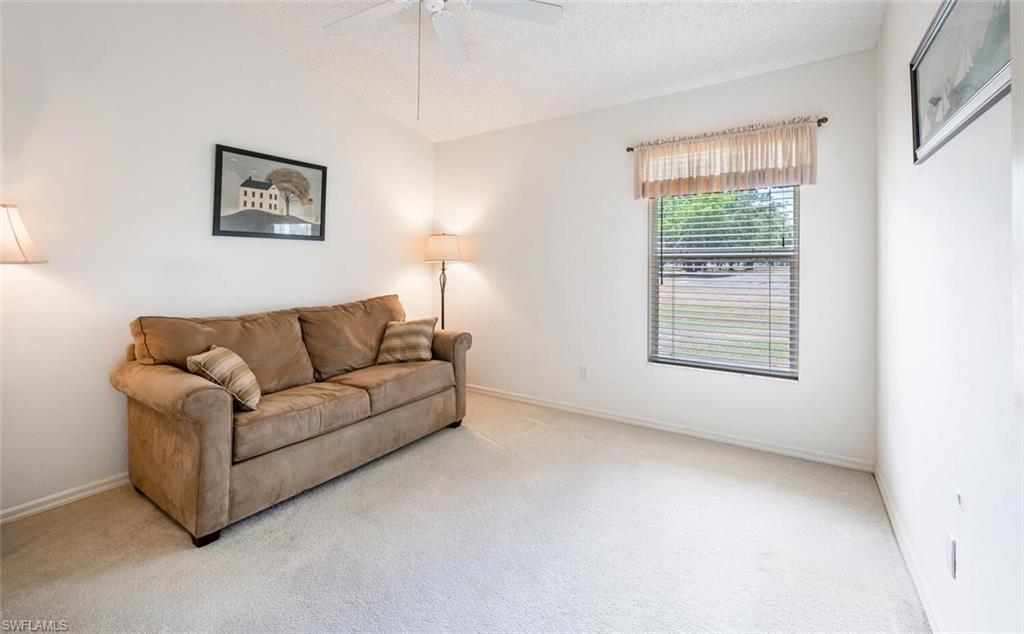 814 Charlemagne Boulevard Naples, FL 34112 - Photo 21 of 33 a living room with furniture and a window