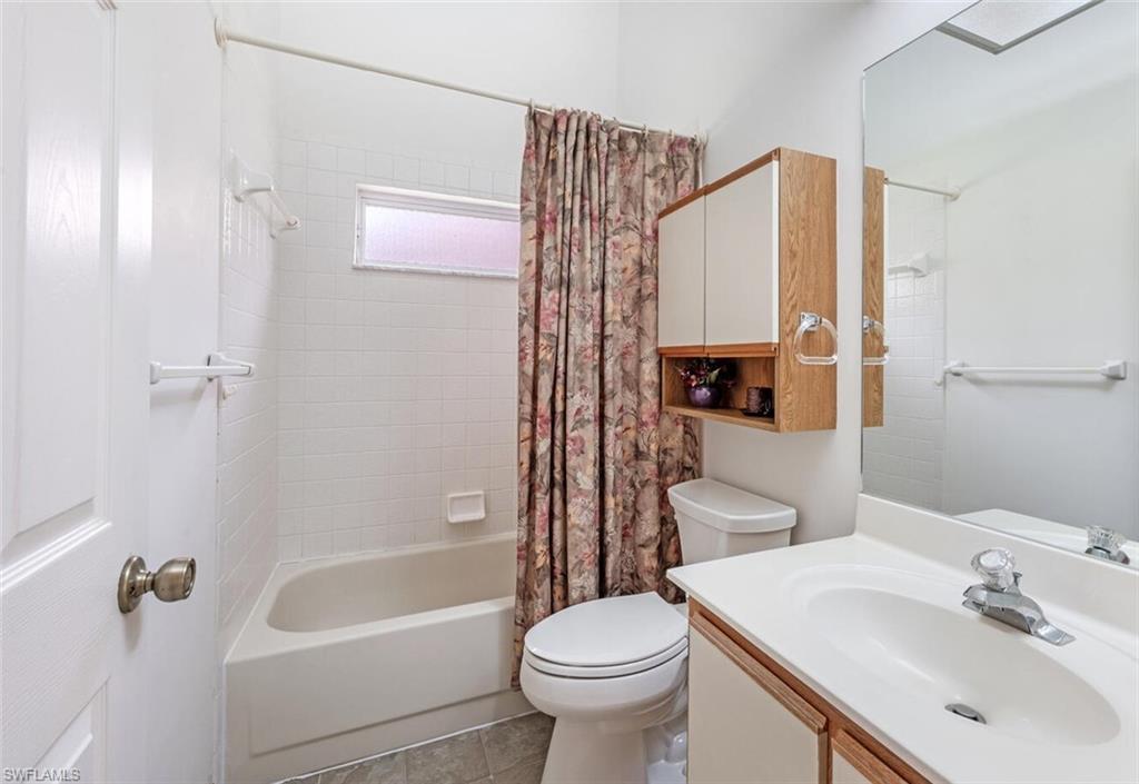 814 Charlemagne Boulevard Naples, FL 34112 - Photo 23 of 33 a bathroom with a sink a toilet and shower