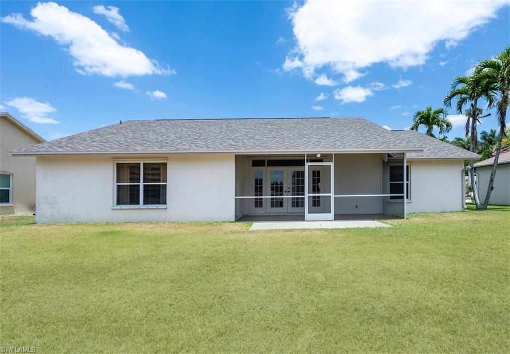 814 Charlemagne Boulevard Naples, FL 34112 - Photo 28 of 33 front view of a house with a yard