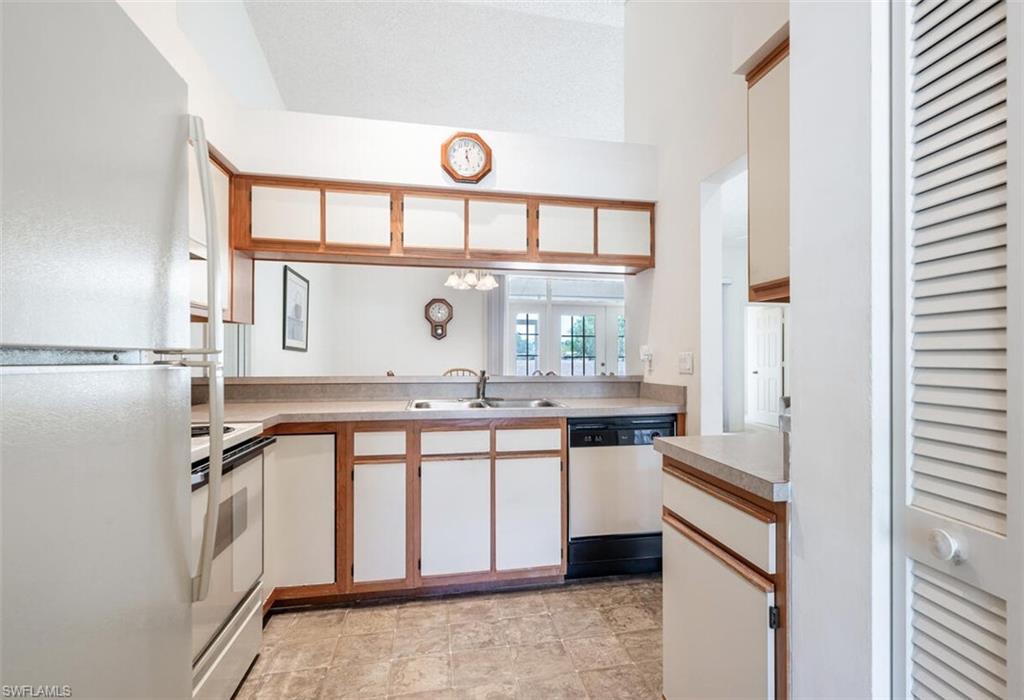 814 Charlemagne Boulevard Naples, FL 34112 - Photo 10 of 33 a kitchen with a sink stove and cabinets