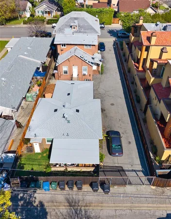 an aerial view of a house with a garden and parking space