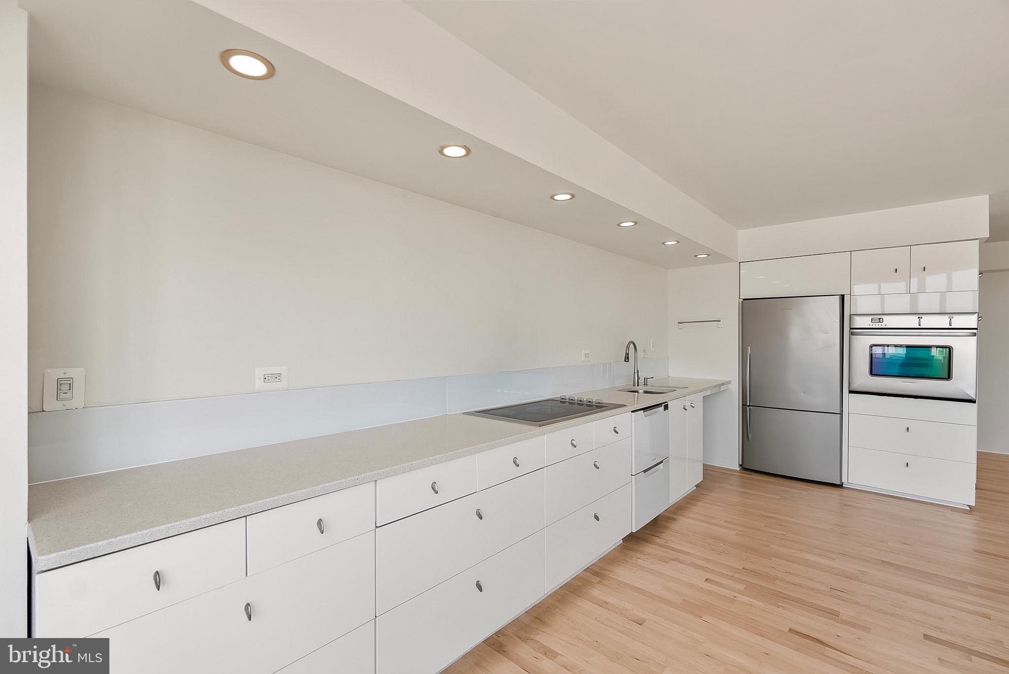 1718 P Street Northwest, Unit 902 Washington, DC 20036 - Photo 18 of 37 Sleek modern kitchen with clean lines.