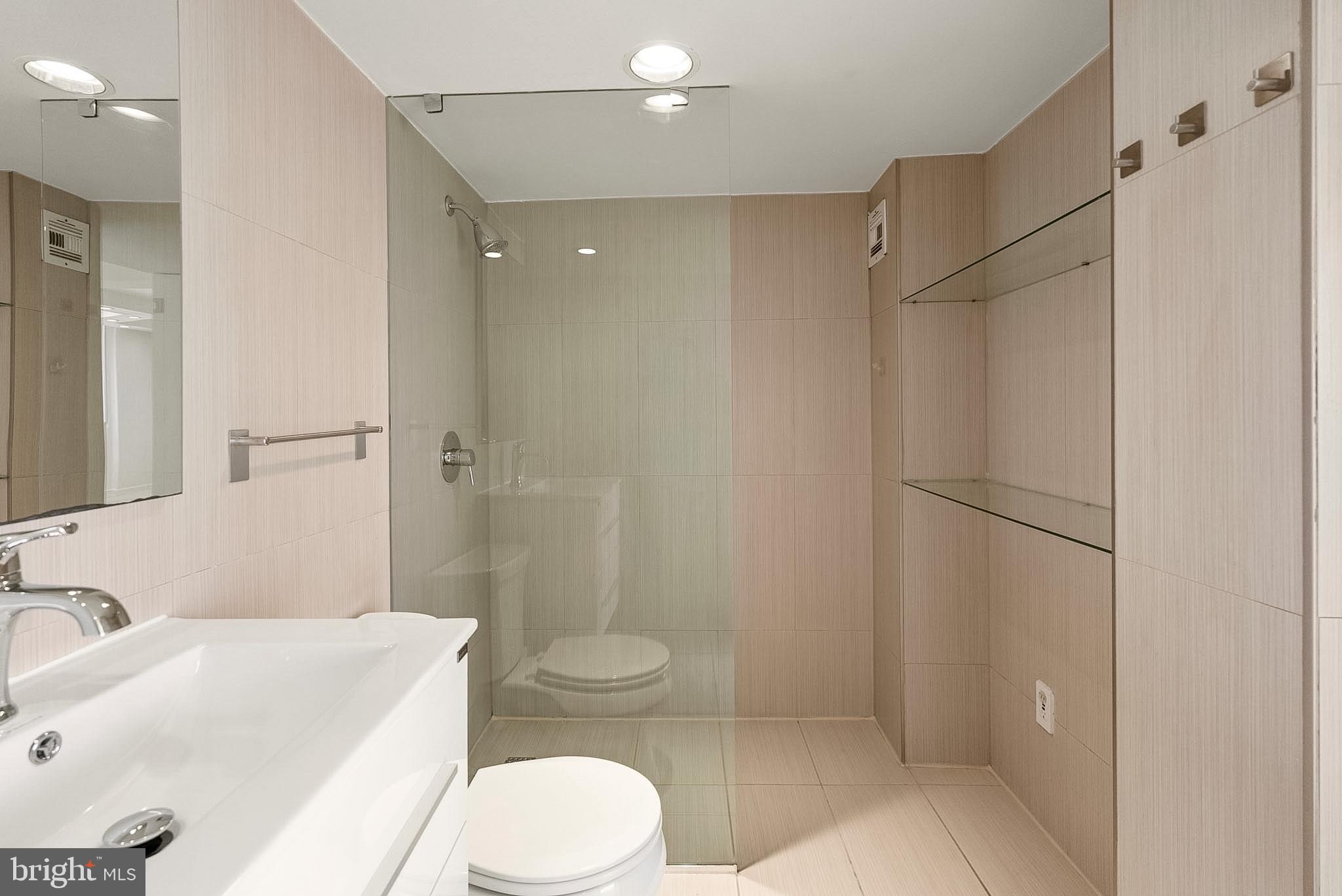 1718 P Street Northwest, Unit 902 Washington, DC 20036 - Photo 28 of 37 Sleek modern bathroom with glass shower.