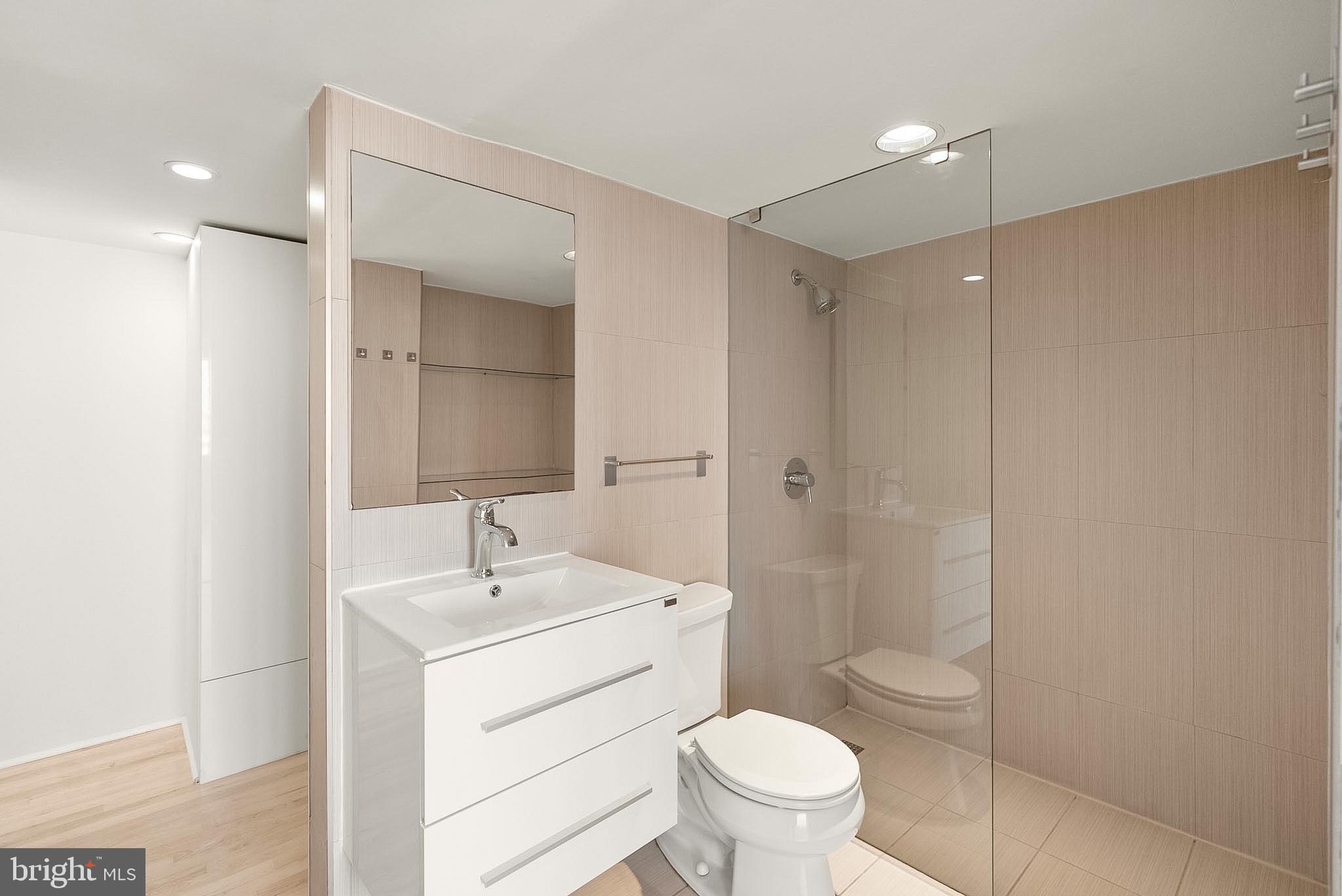 1718 P Street Northwest, Unit 902 Washington, DC 20036 - Photo 29 of 37 Sleek modern bathroom with glass shower.