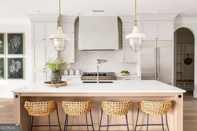 2701 Conns Creek Road, Unit 40 Ball Ground, GA 30107 - Photo 14 of 16 a kitchen with stainless steel appliances kitchen island granite countertop a table chairs and a refrigerator