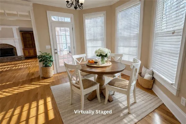 a dining room with furniture and wooden floor