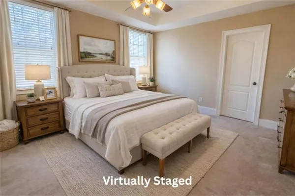 a bedroom with a bed and a painting on the wall