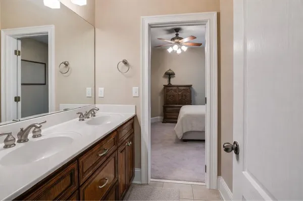 a en suite bathroom with a sink double vanity and a mirror