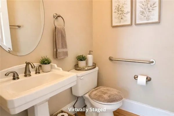 a bathroom with a sink mirror and toilet