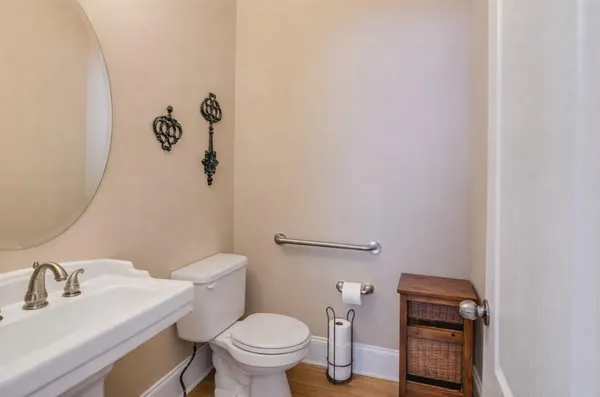 a bathroom with a sink a toilet and vanity