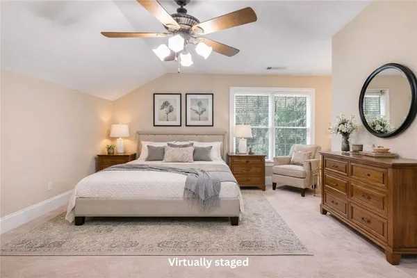 a bedroom with a bed a couch and a chandelier