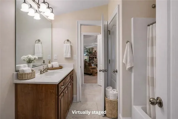 a bathroom with a sink vanity and a mirror