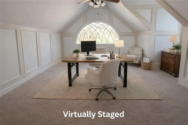 a view of a livingroom with workspace and a window