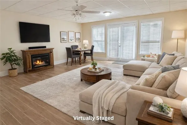 a living room with furniture a fireplace and a flat screen tv