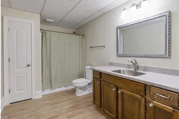 a bathroom with a toilet a sink a vanity and mirror