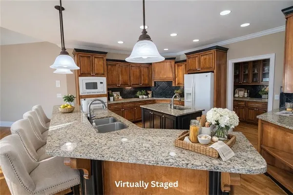 a living room with granite countertop furniture a rug and a chandelier