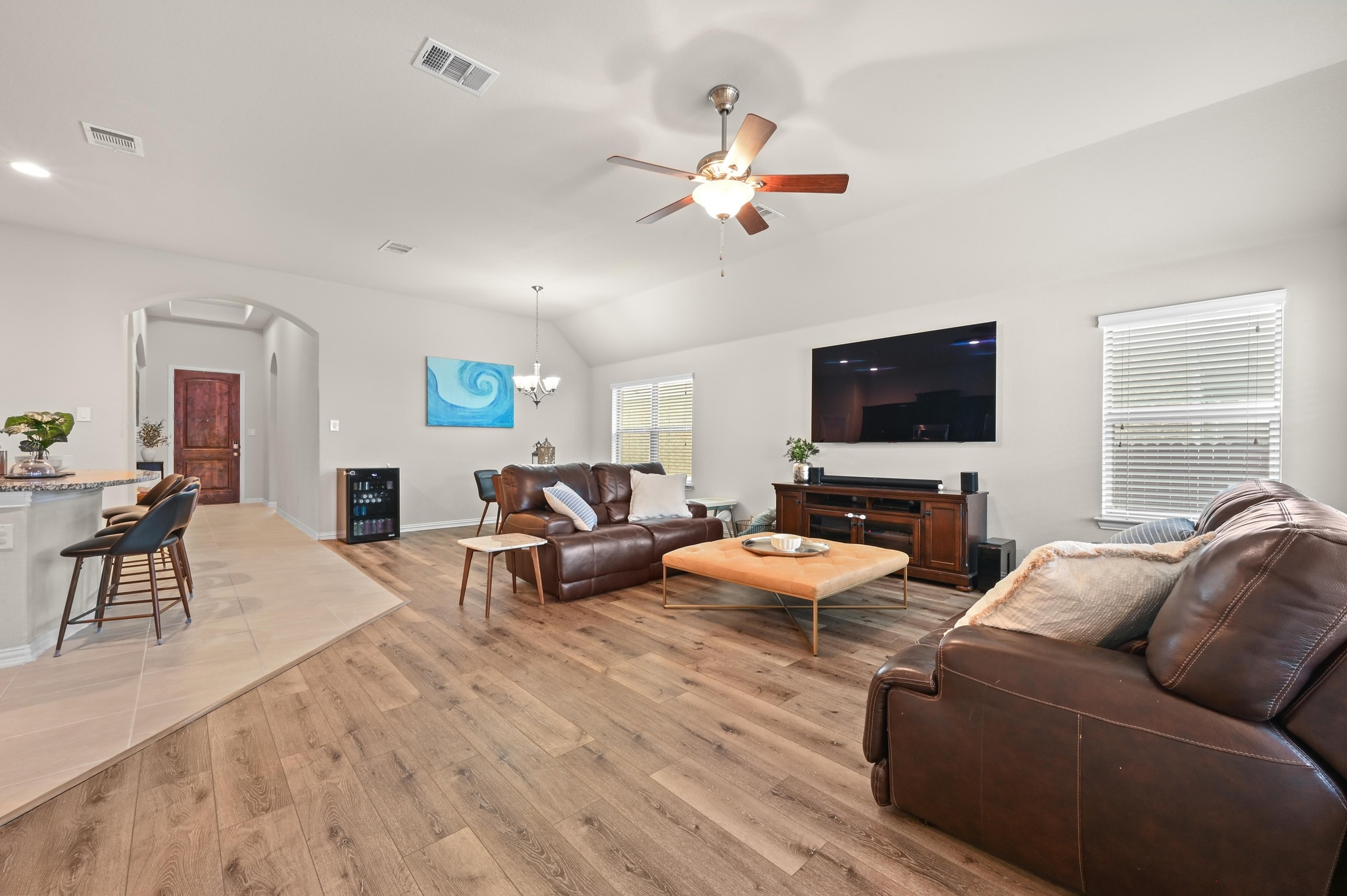 546 Hot Spring Valley Buda, TX 78610 - Photo 13 of 27 Living room with arched walkways, ceiling fan, suspended lighting, light wood-type flooring, and lofted ceiling