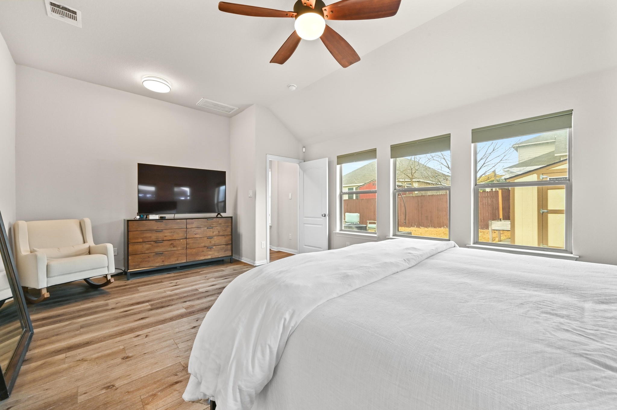 546 Hot Spring Valley Buda, TX 78610 - Photo 16 of 27 Bedroom with light wood-style floors, lofted ceiling, and ceiling fan