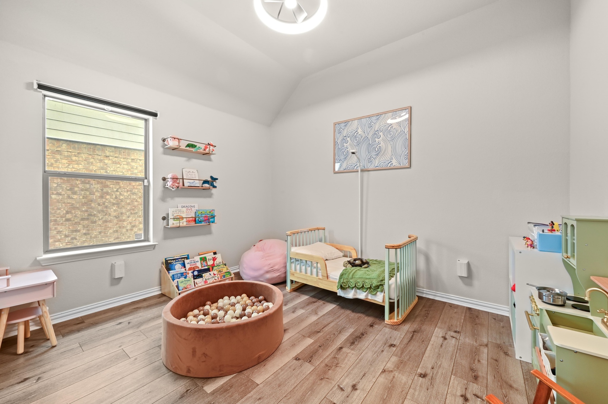 546 Hot Spring Valley Buda, TX 78610 - Photo 21 of 27 Bedroom with lofted ceiling and light wood finished floors