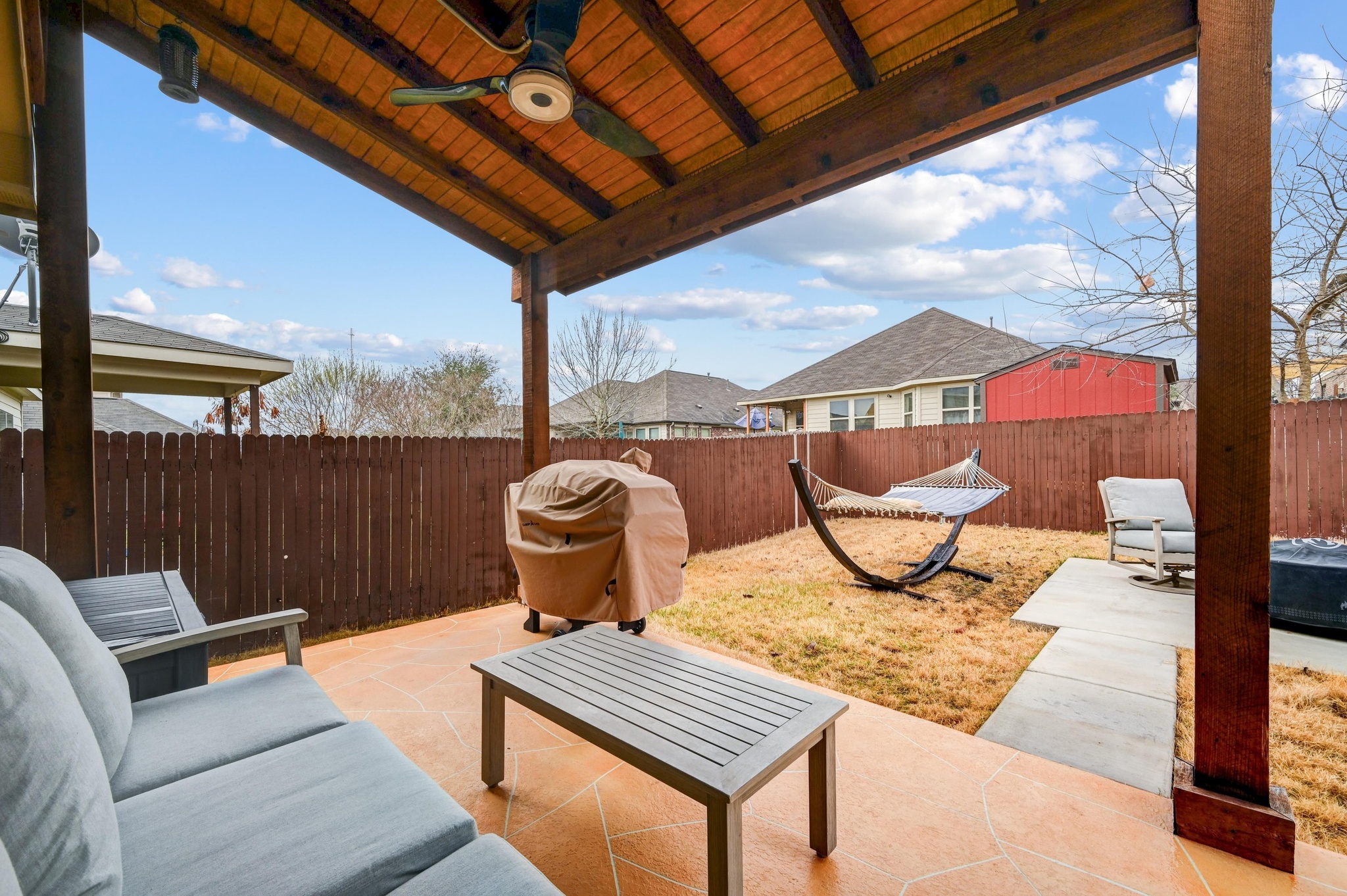 546 Hot Spring Valley Buda, TX 78610 - Photo 24 of 27 Fenced backyard featuring a patio area, ceiling fan, grilling area, and outdoor seating