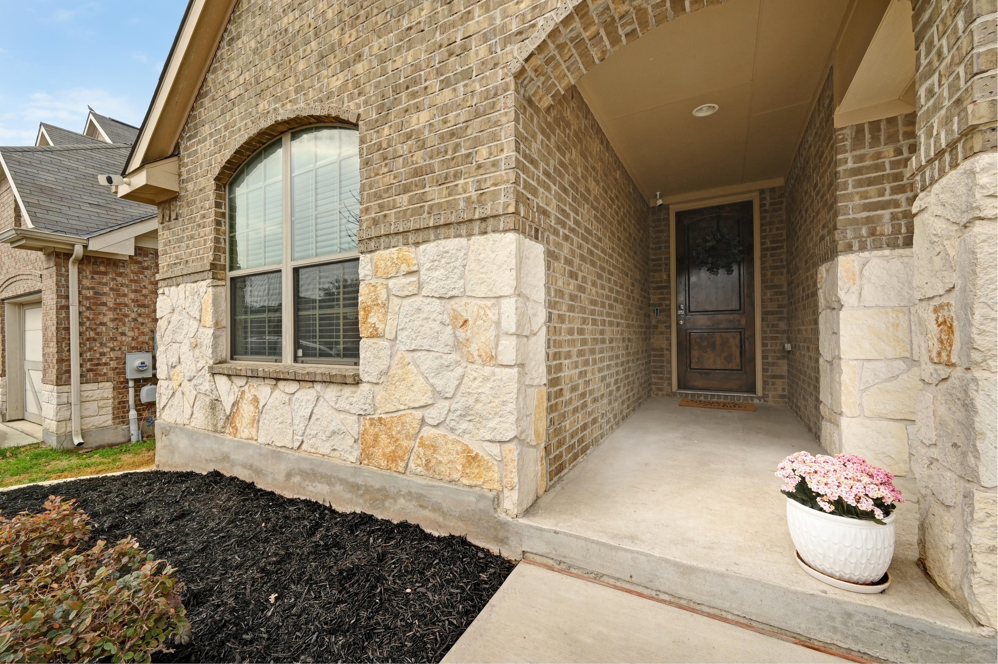 546 Hot Spring Valley Buda, TX 78610 - Photo 4 of 27 Doorway to property with stone siding and brick siding