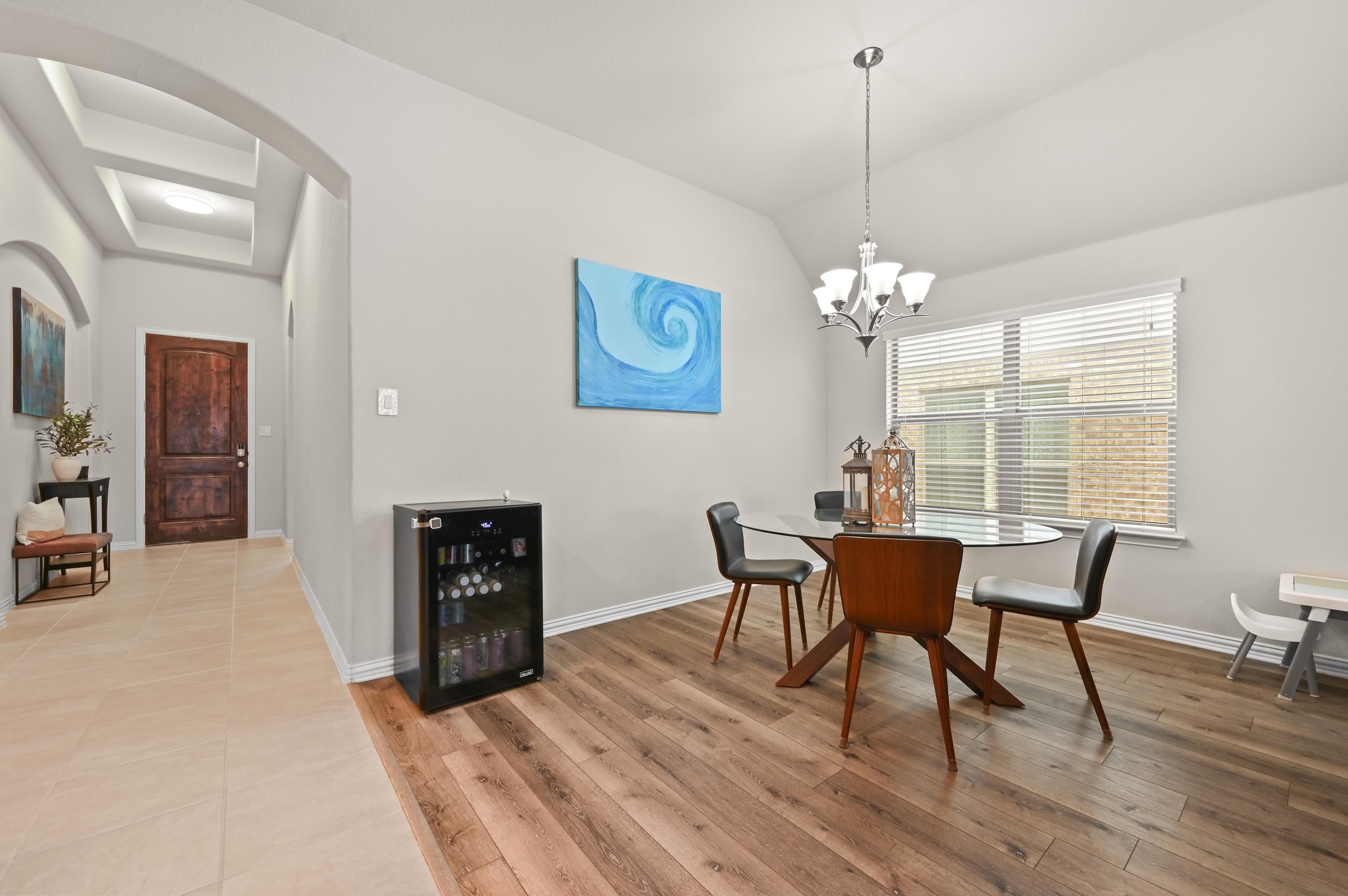 546 Hot Spring Valley Buda, TX 78610 - Photo 8 of 27 Dining area with wine cooler, light wood finished floors, lofted ceiling, and a chandelier