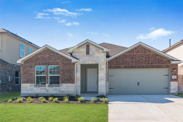 a front view of a house with a yard