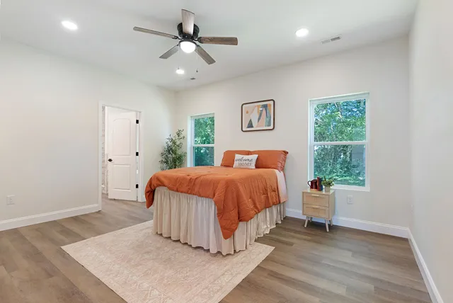 a spacious bedroom with a bed and a window