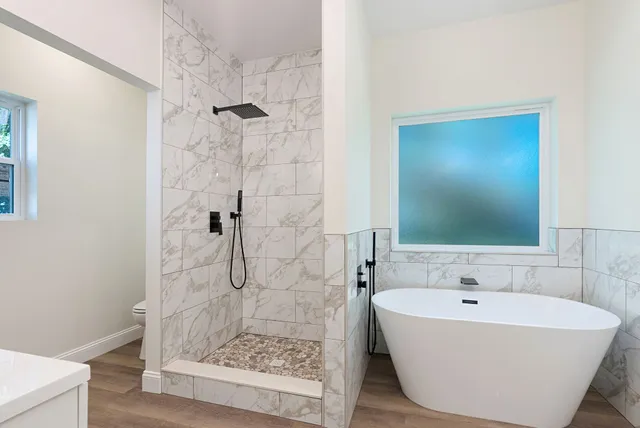 a bathroom with a bathtub and shower