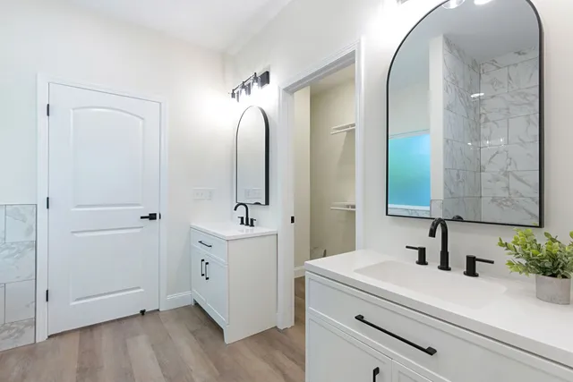 a bathroom with a double vanity sink mirror and