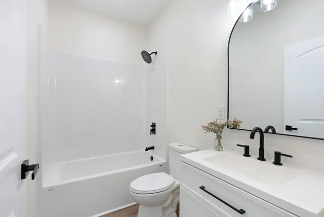 a bathroom with a sink a toilet and a mirror