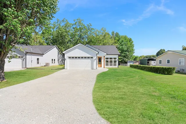 a front view of a house with garden