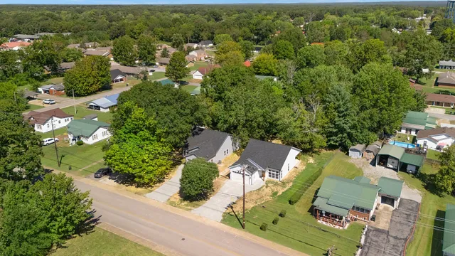 an aerial view of residential houses with outdoor space and street view