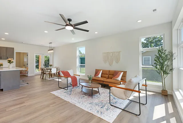 a living room with furniture and a ceiling fan