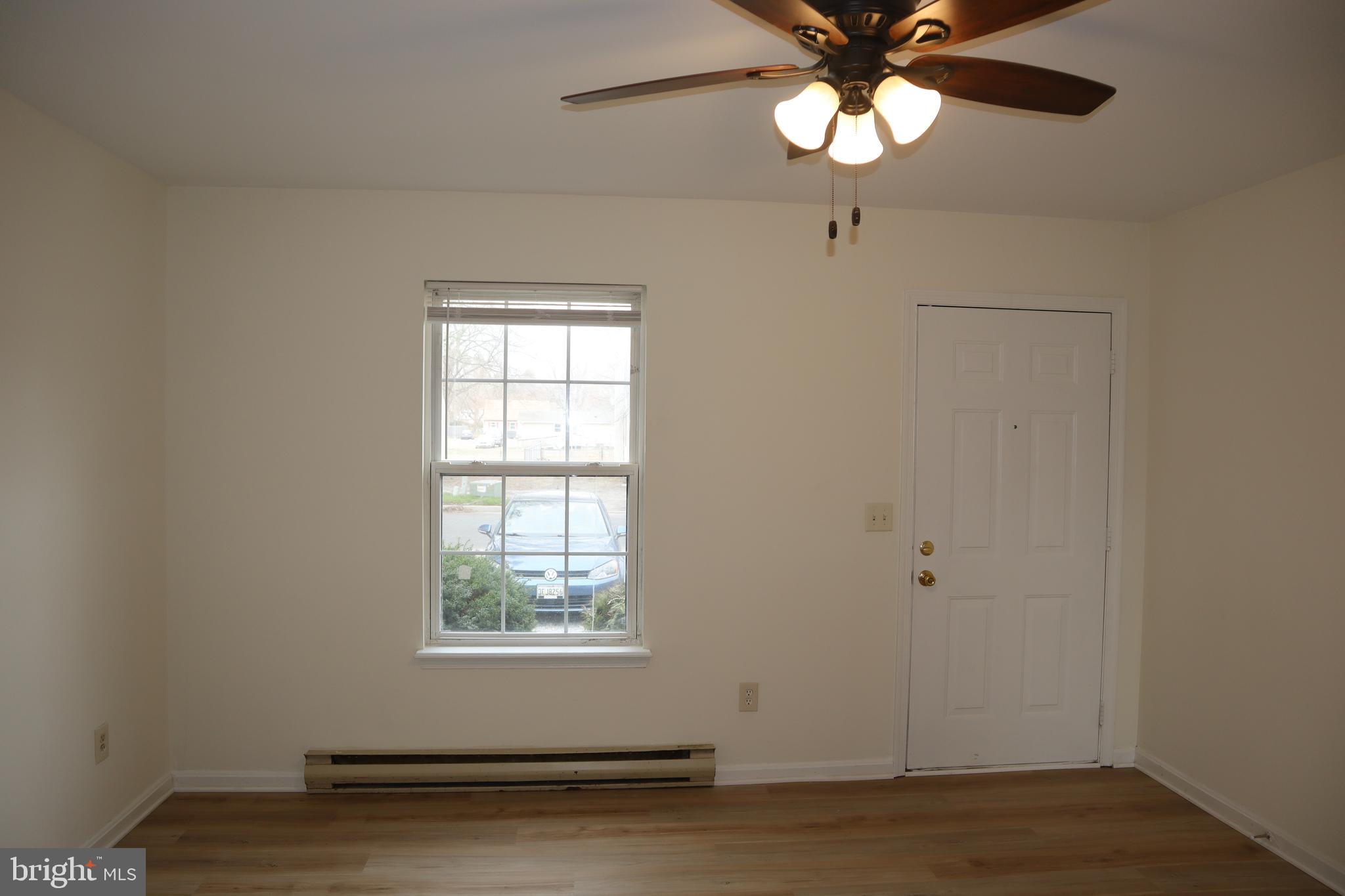 2 West Pine Street Delmar, MD 21875 - Photo 3 of 23 wooden floor in an empty room with a window