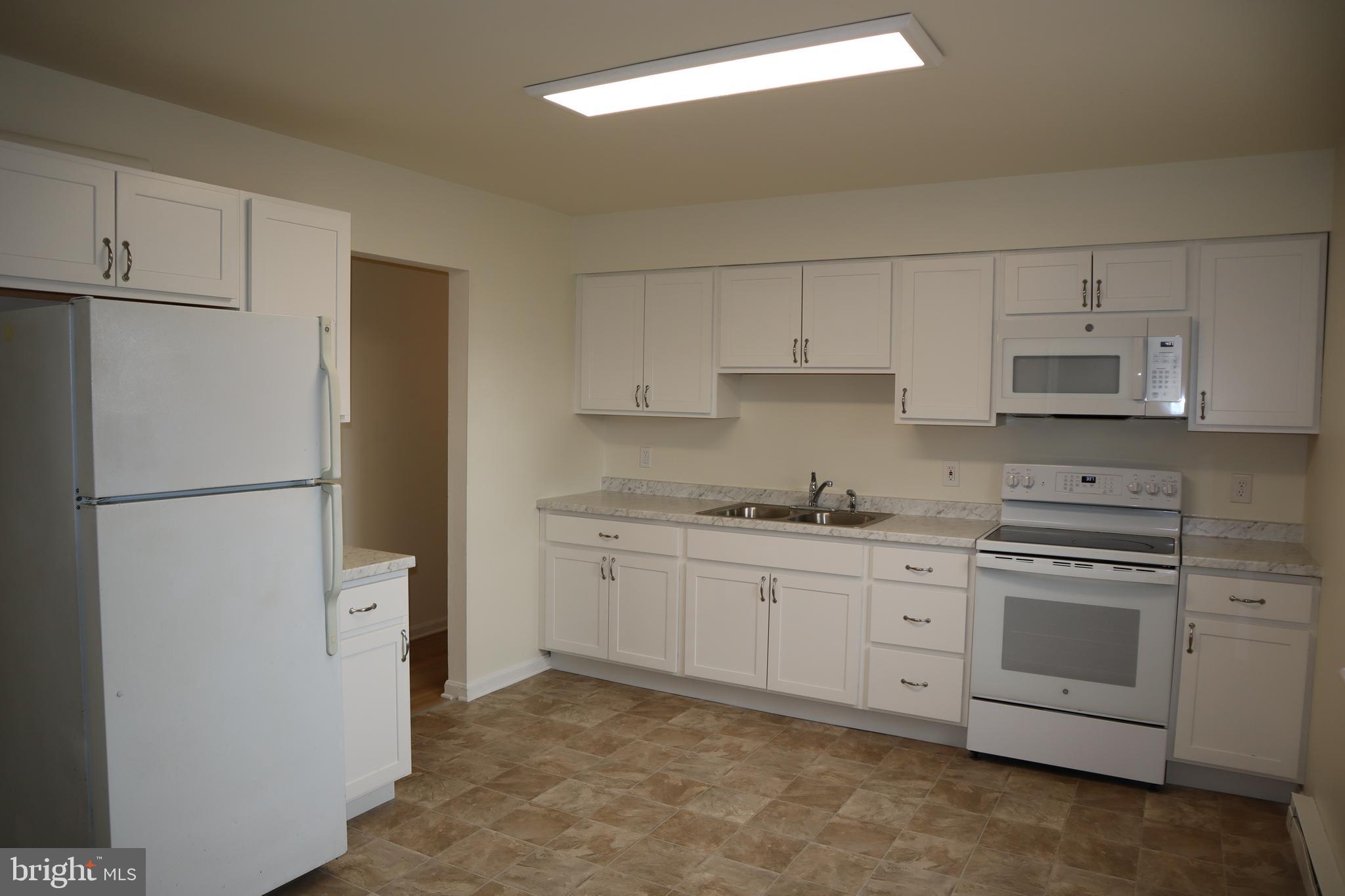 2 West Pine Street Delmar, MD 21875 - Photo 6 of 23 a kitchen with stainless steel appliances granite countertop white refrigerator stove a sink and dishwasher