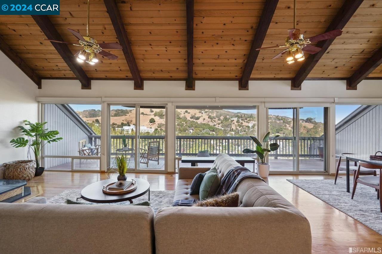 901 Harbor View Drive Martinez, CA 94553 - Photo 1 of 1 a living room with furniture and a floor to ceiling window